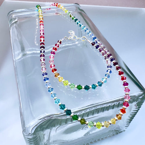 Colorful beaded necklace on a clear glass surface