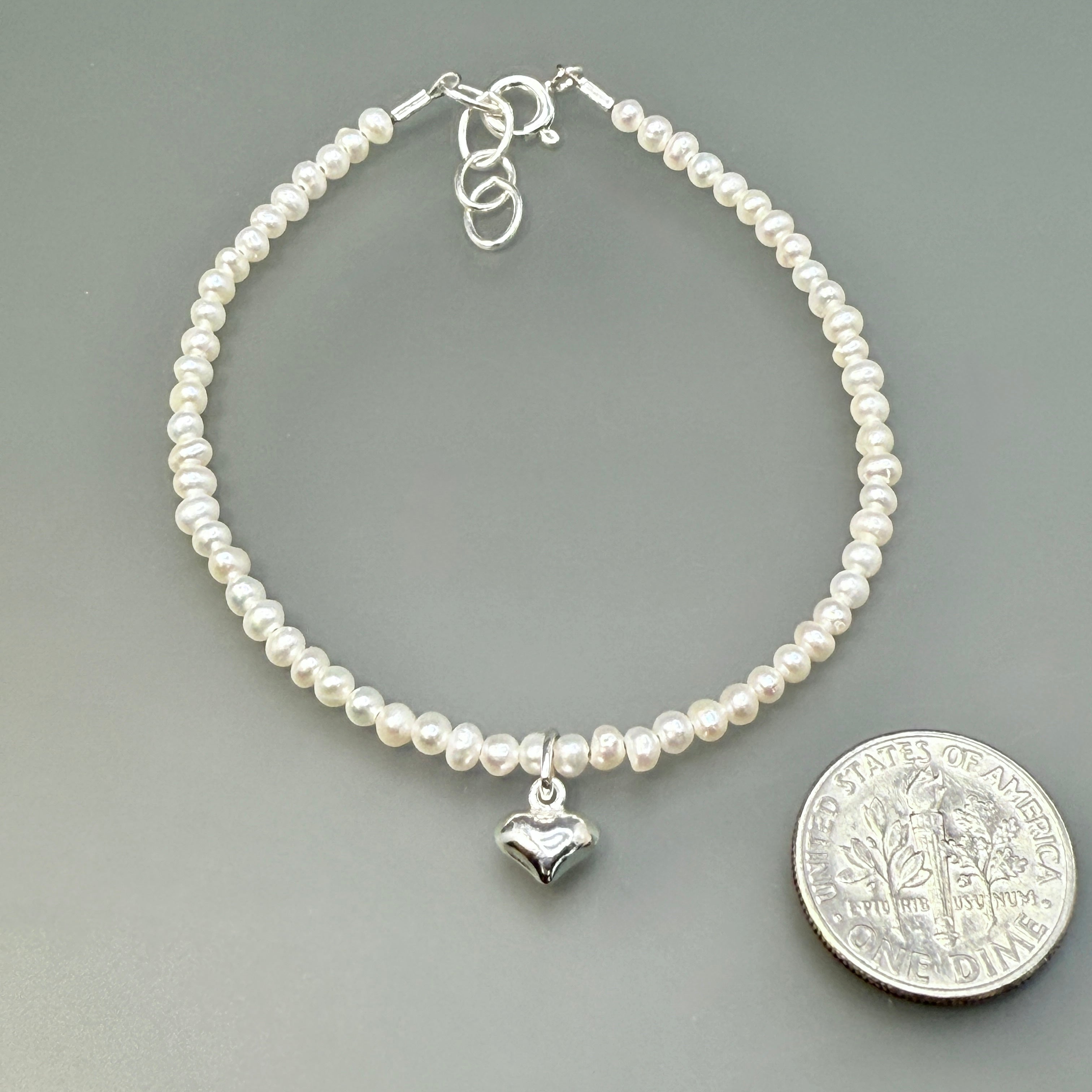 Sterling silver tiny heart on white pearls bracelet