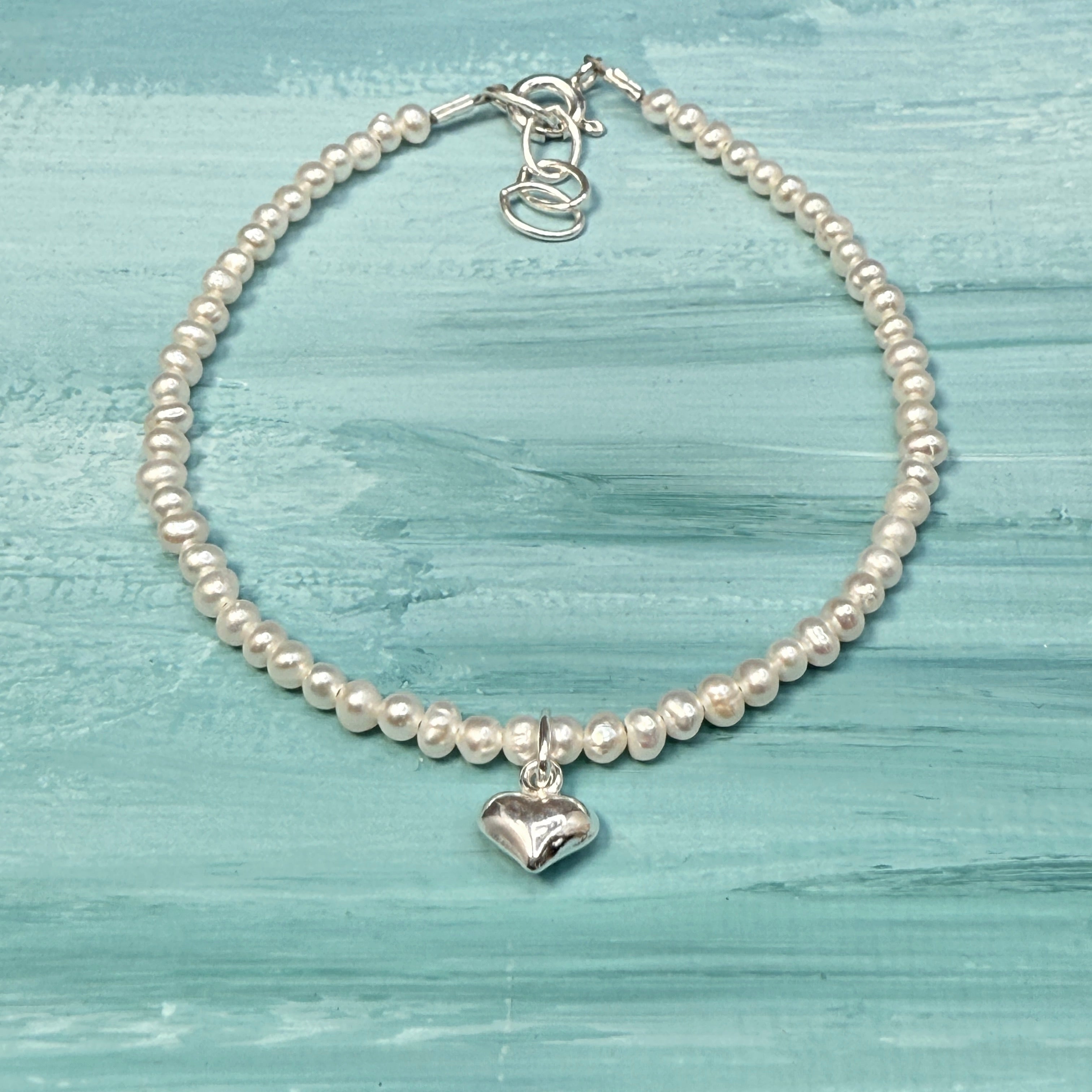 Sterling silver tiny heart on white pearls bracelet