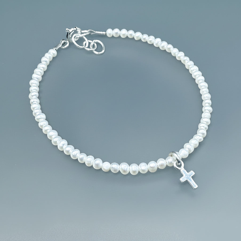 Sterling silver tiny cross on white pearls bracelet