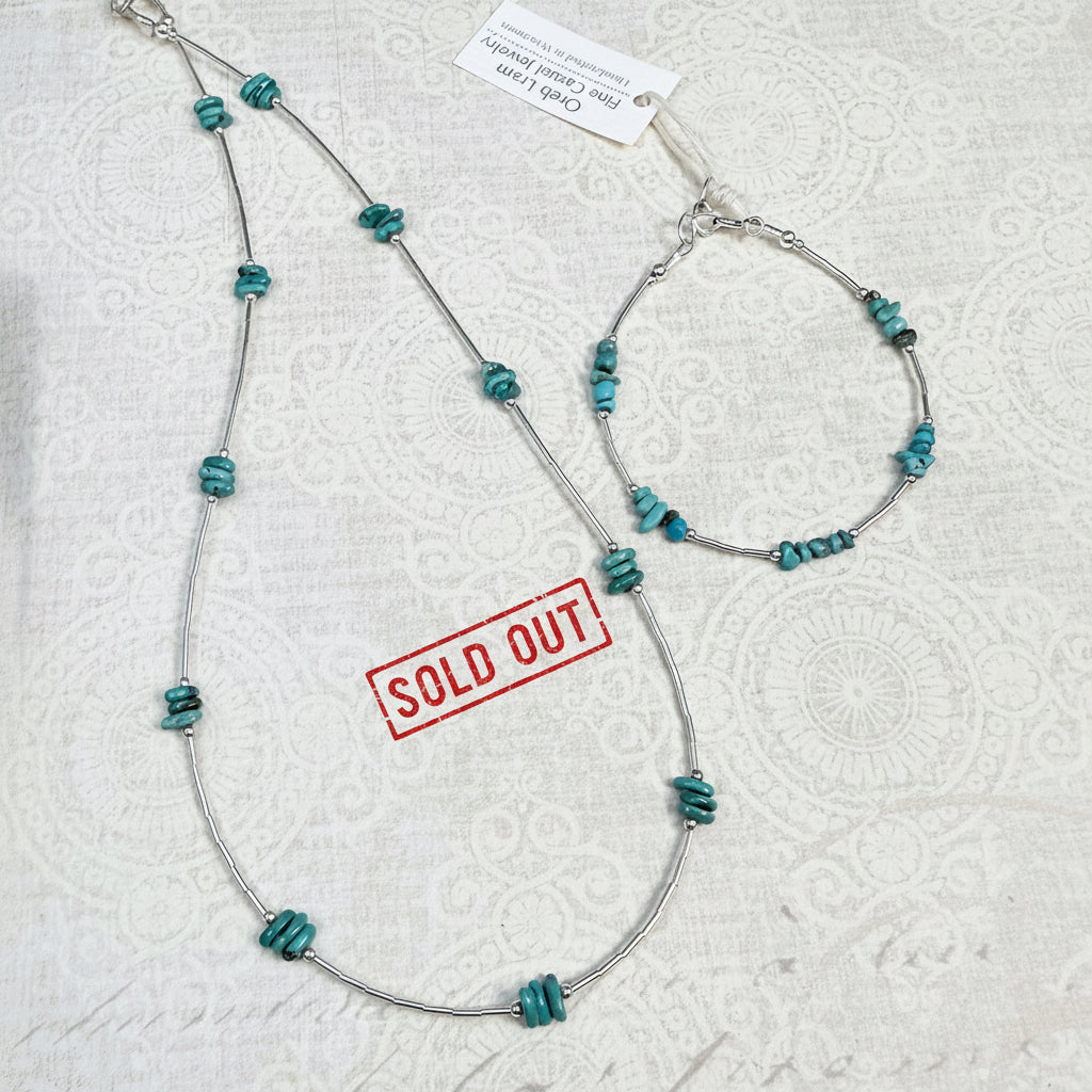 Turquoise and silver necklace and bracelet on an off white textured background. Necklace is shown as sold out.