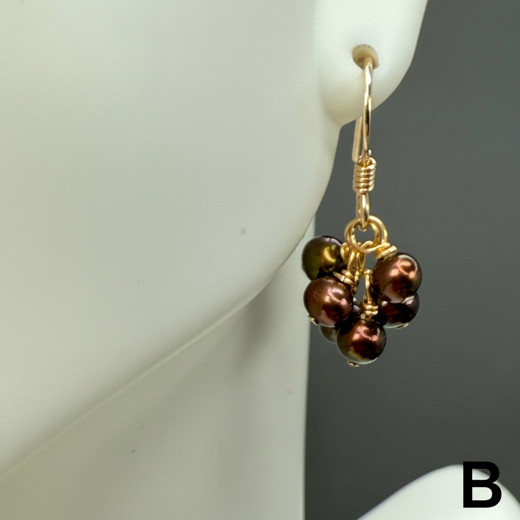 Brown pearl cluster earrings with gold hooks and accents, shown on a white display. The letter B is shown at bottom right of photo