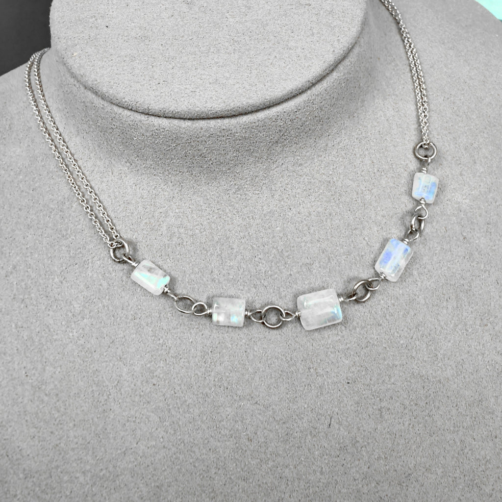 Necklace with rainbow moonstone beads on a mannequin