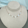 Necklace with rectangular rainbow moonstone beads on a gray bust
