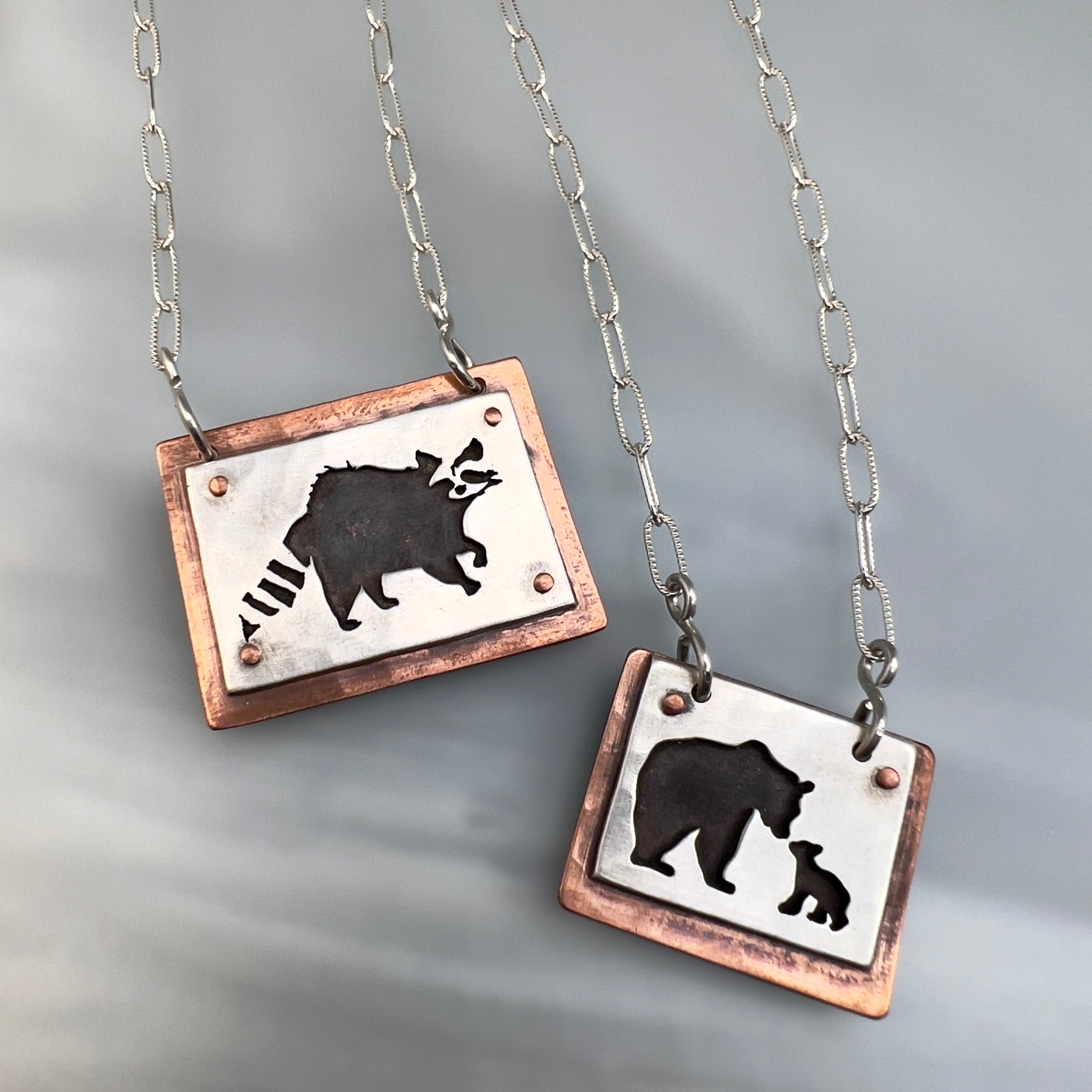 Hand cut Pendants in sterling silver and copper